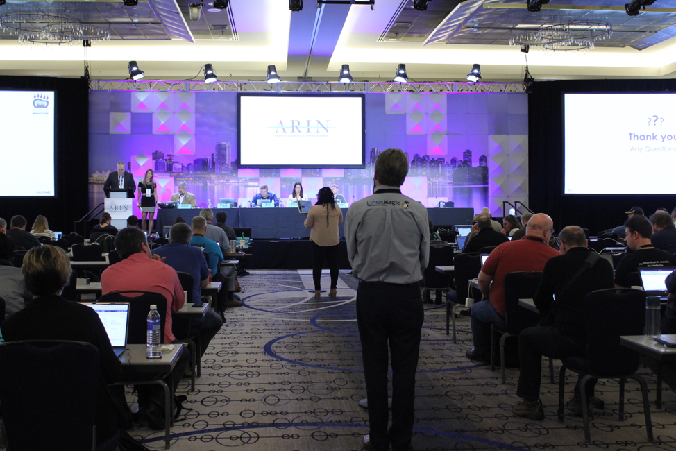 Attendees speak at the meeting.